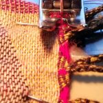 Stitching a halved Pashmina shawl back together.