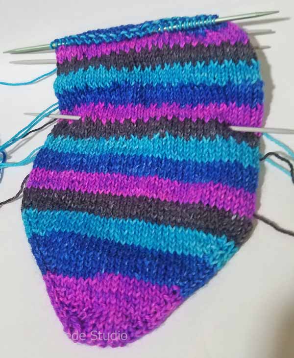 Reknitting what was frogged in K1B on the first row of each new color. Softer than the straight stripes and a bit more interesting to knit.