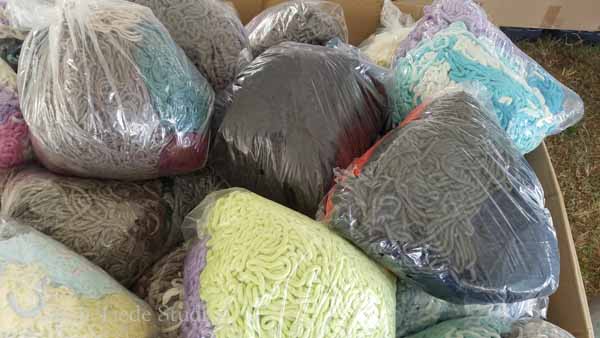 A bin of unspooled yarn, in bags of 2-5 skeins, $2/bag.
