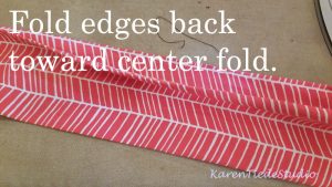 Fold the edges back to the center fold line.