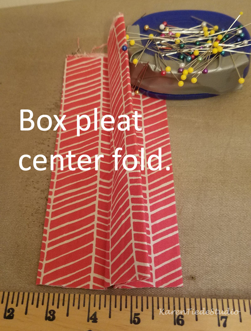 Make a box pleat out of the center fold.