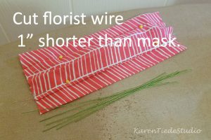 Cut light florist wire 1" shorter than mask.
