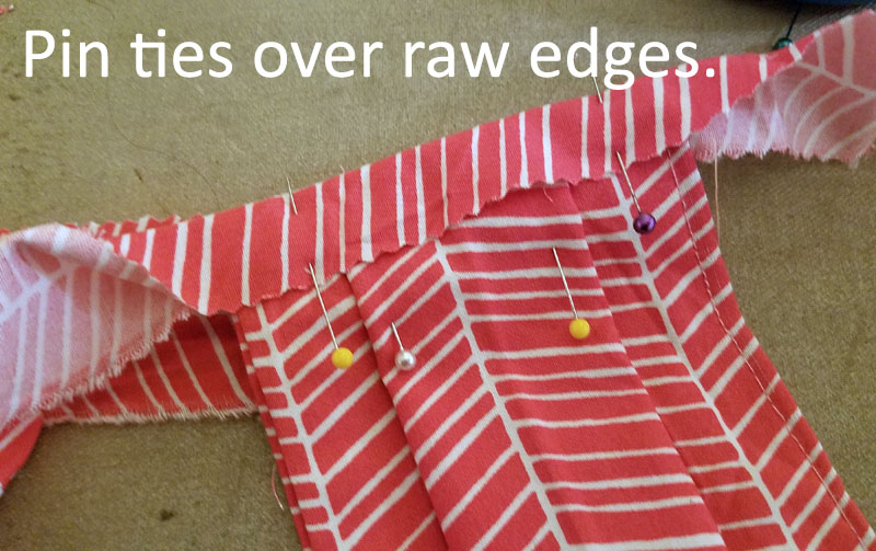Fold ties over raw edges and pin.