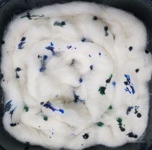 Blue and green food coloring dropped directly onto the roving.