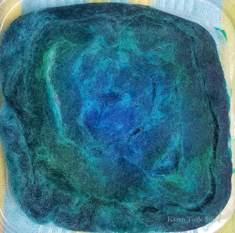 After many short cycles in the microwave. Turned roving over to let dye percolate to the pale side.
